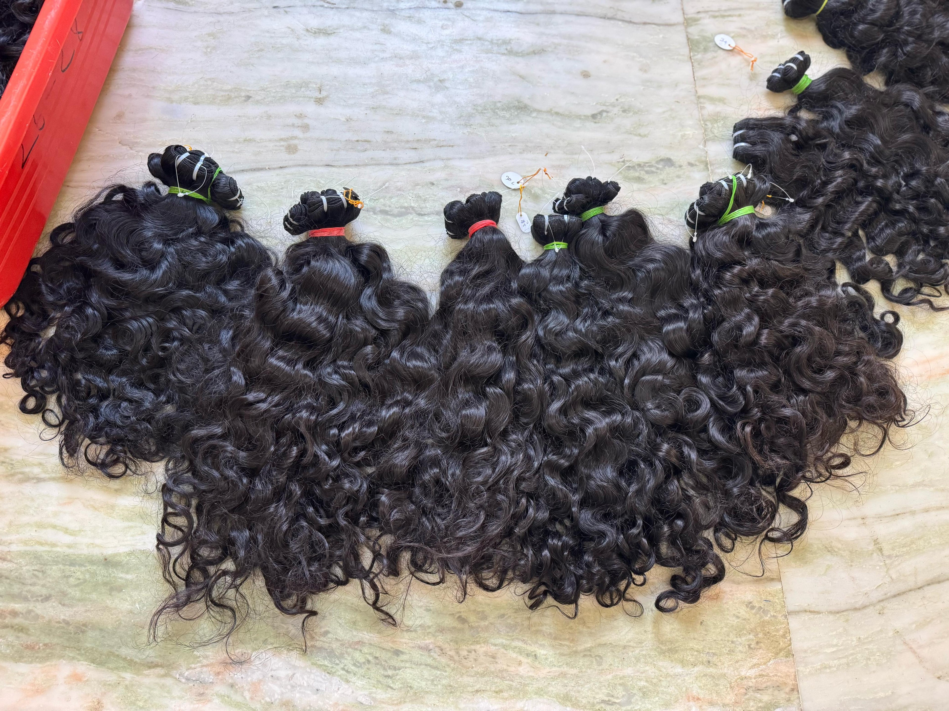 Curly hair extensions on a textured surface